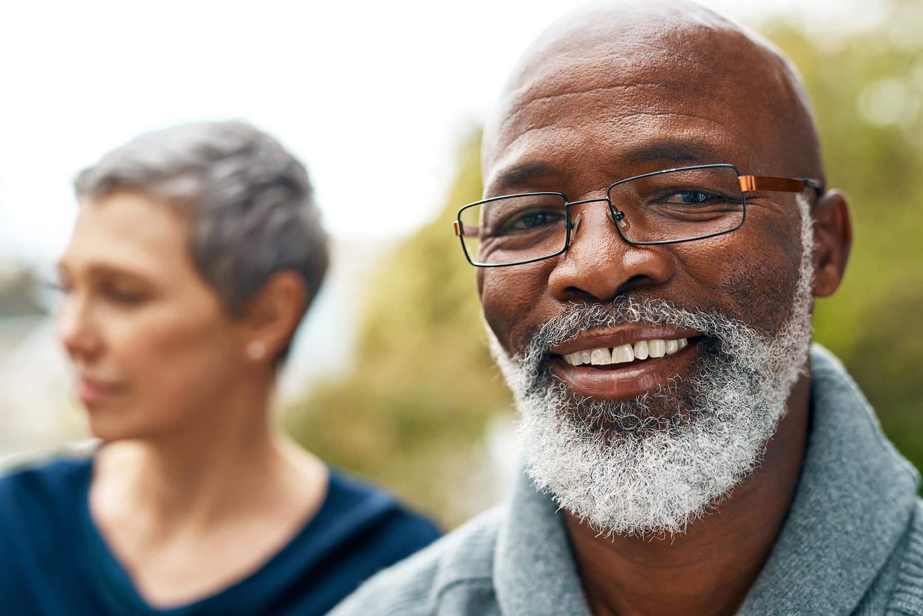 Man smiling after getting an oral cancer screening in Louisville, CO