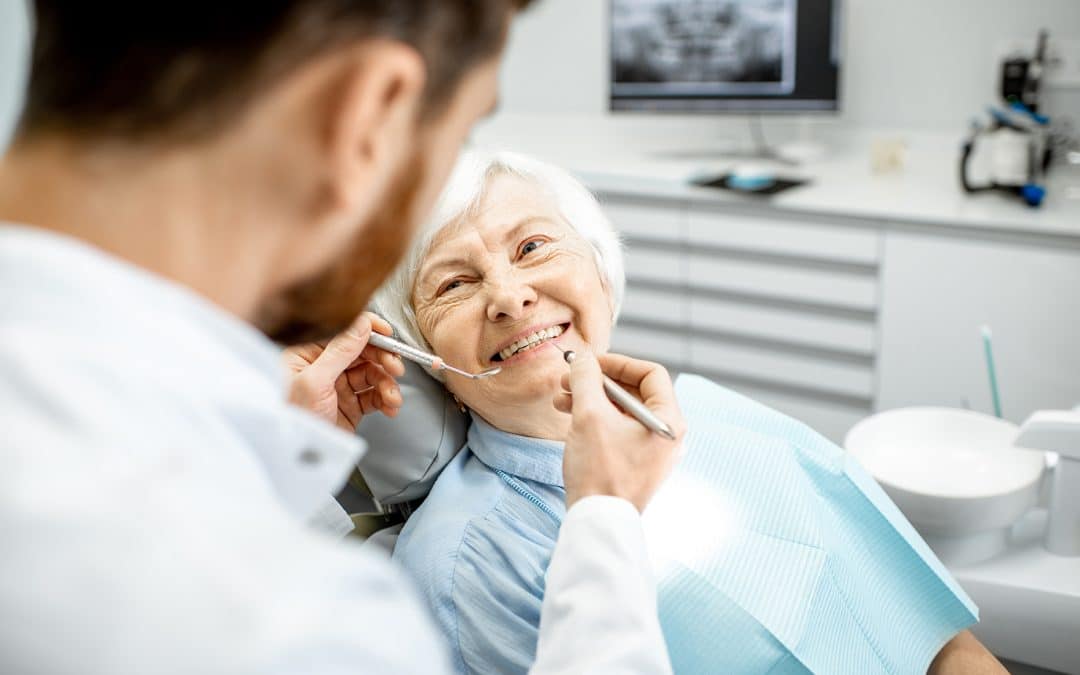 woman with gum disease smiling during a periodontal appointment at the dentist in louisville