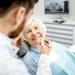 woman with gum disease smiling during a periodontal appointment at the dentist in louisville