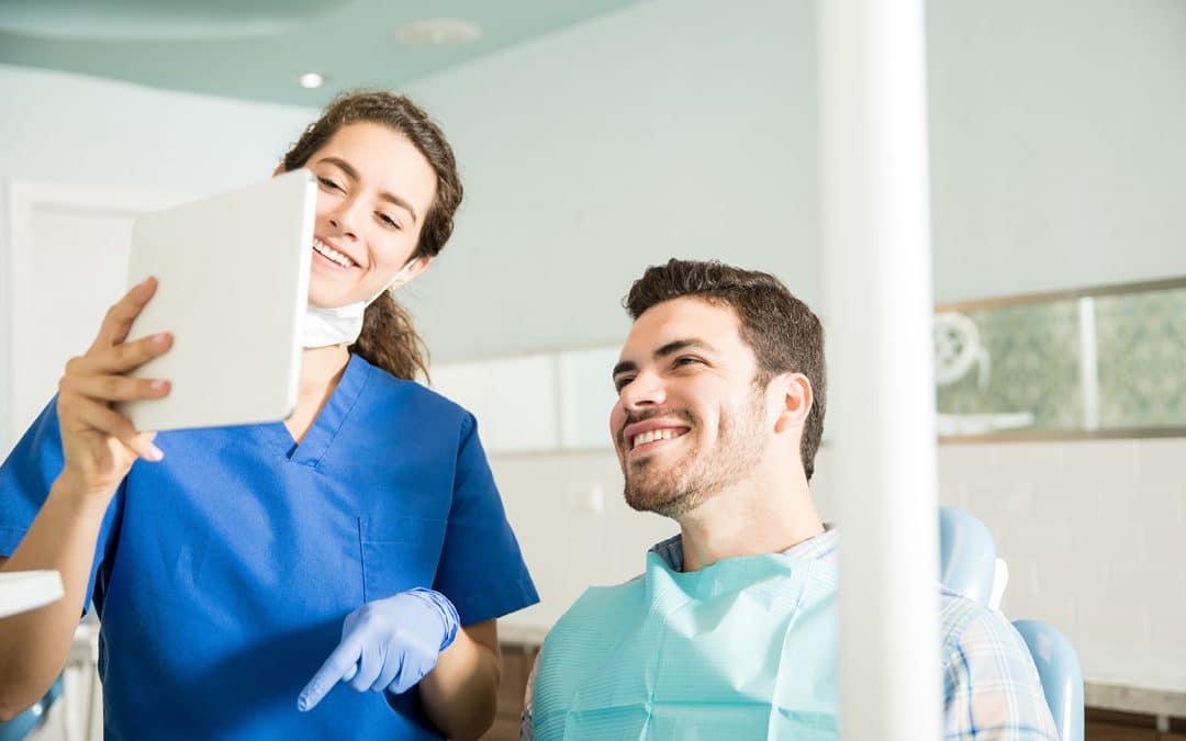 male patient smiling during dental exam at the dentist in louisville