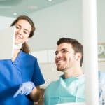 male patient smiling during dental exam at the dentist in louisville