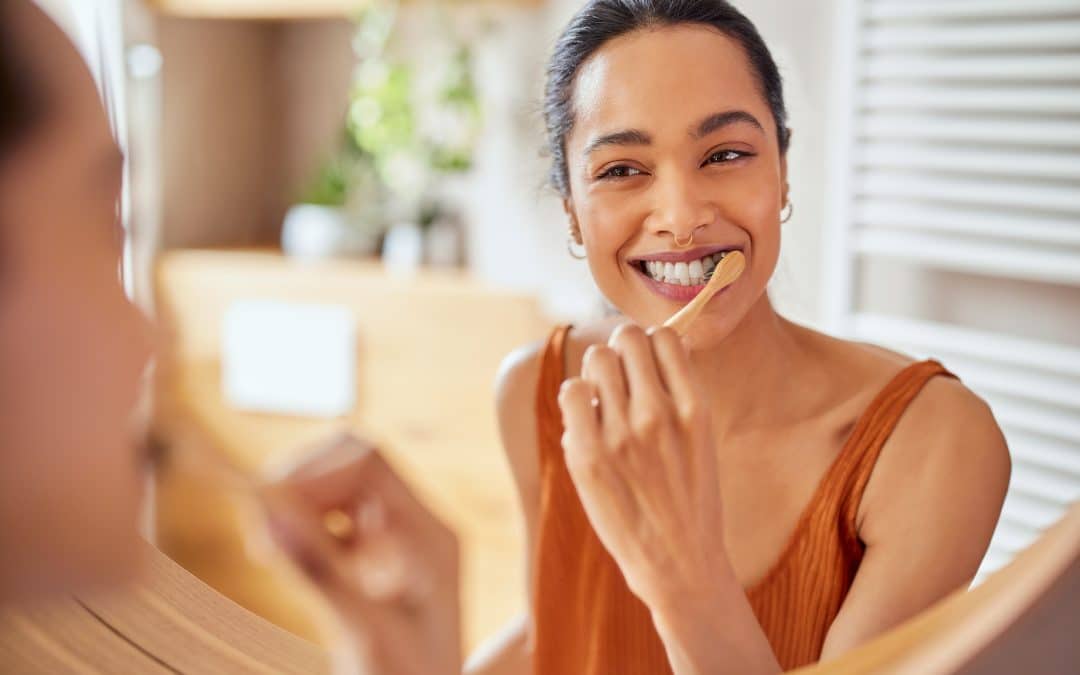 woman brushing her teeth using at home dental care tips from the dentist in louisville