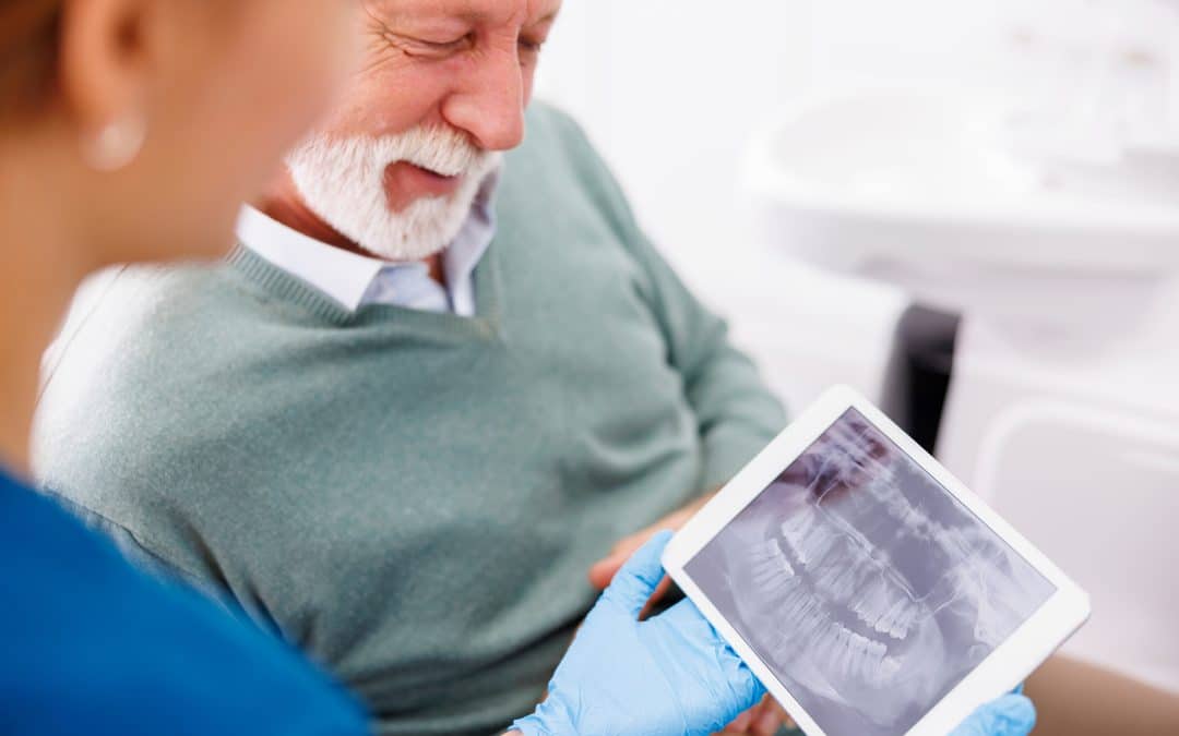 dr barta showing male dental xrays during dentistry for senior appointment at the dentist in louisville