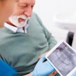 dr barta showing male dental xrays during dentistry for senior appointment at the dentist in louisville