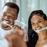 Happy couple brushing their teeth in Louisville, KY